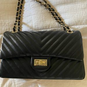 Looks like chanel but its not. Quilted black purse